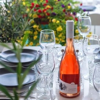 A table set with a bottle of Rose Wine
