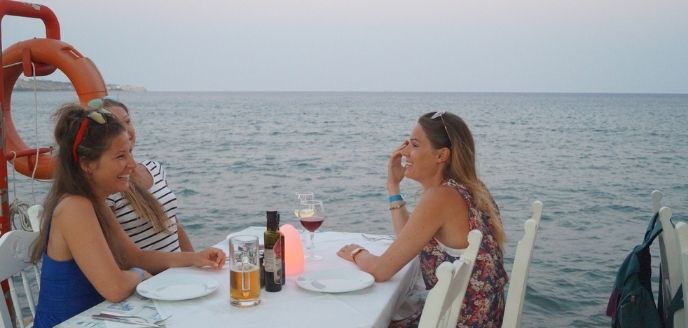 3 girls sitting in a seaside restaurant