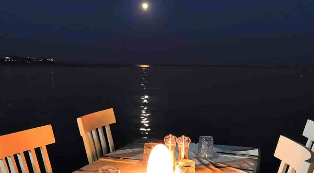 A set table by moonlight at Zorbas Seaside Restaurant