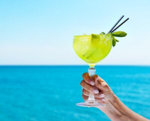 A green cocktail in front of the sea