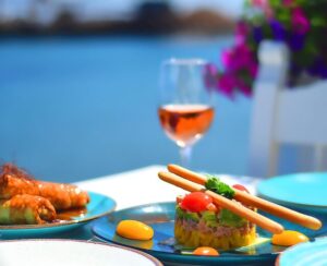Plates of salmon tartar and a glass of rose wine at the seafront