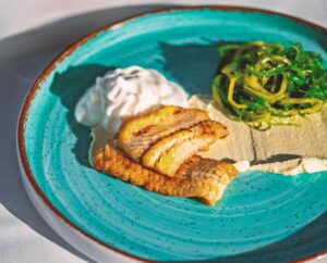 A green plate on atable at Zorbas Seaside Restaurant